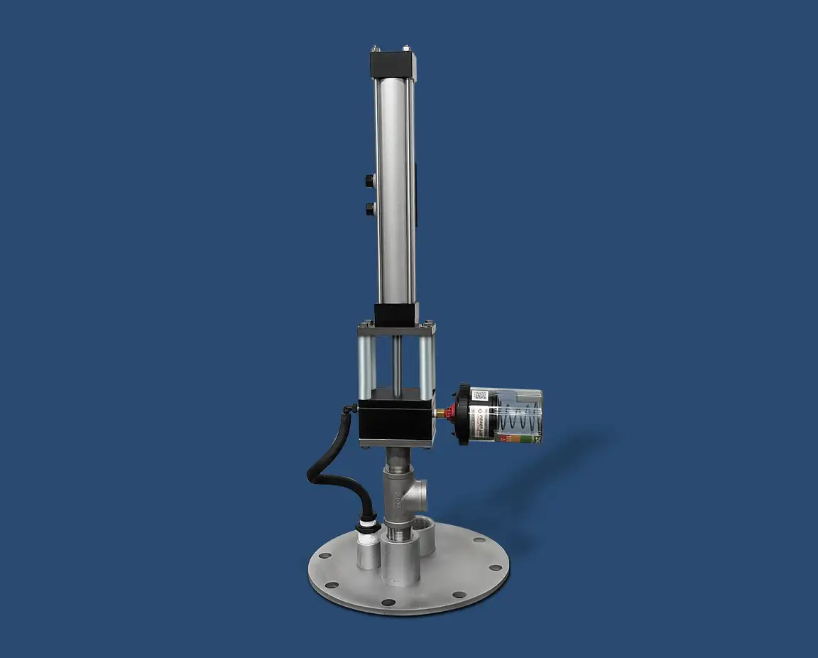 Image of an industrial pneumatic cylinder with a metal base and vertical design. It includes a motor attached to the side, a black cable connecting components, and features a top-head drive pump. The background is solid blue.